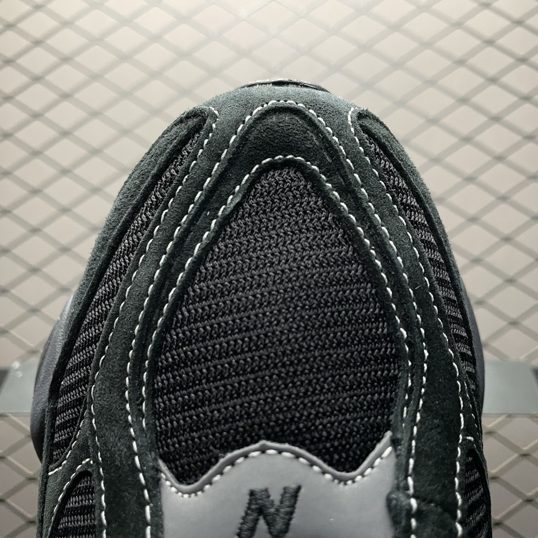 New Balance 9060 Triple Black sneakers worn by a model, showcasing street style appeal