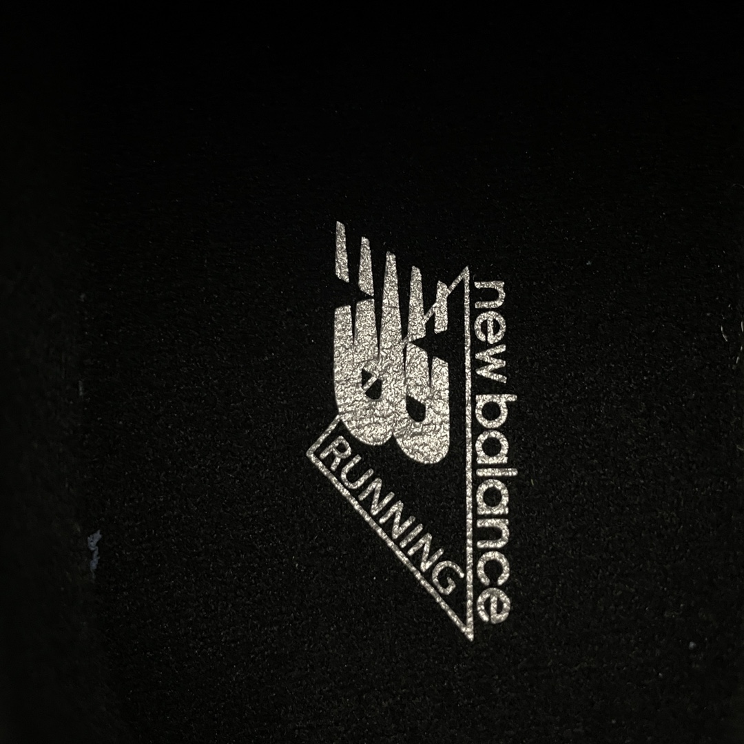Detailed shot of New Balance 9060 Triple Black 'N' logo and midsole cushioning